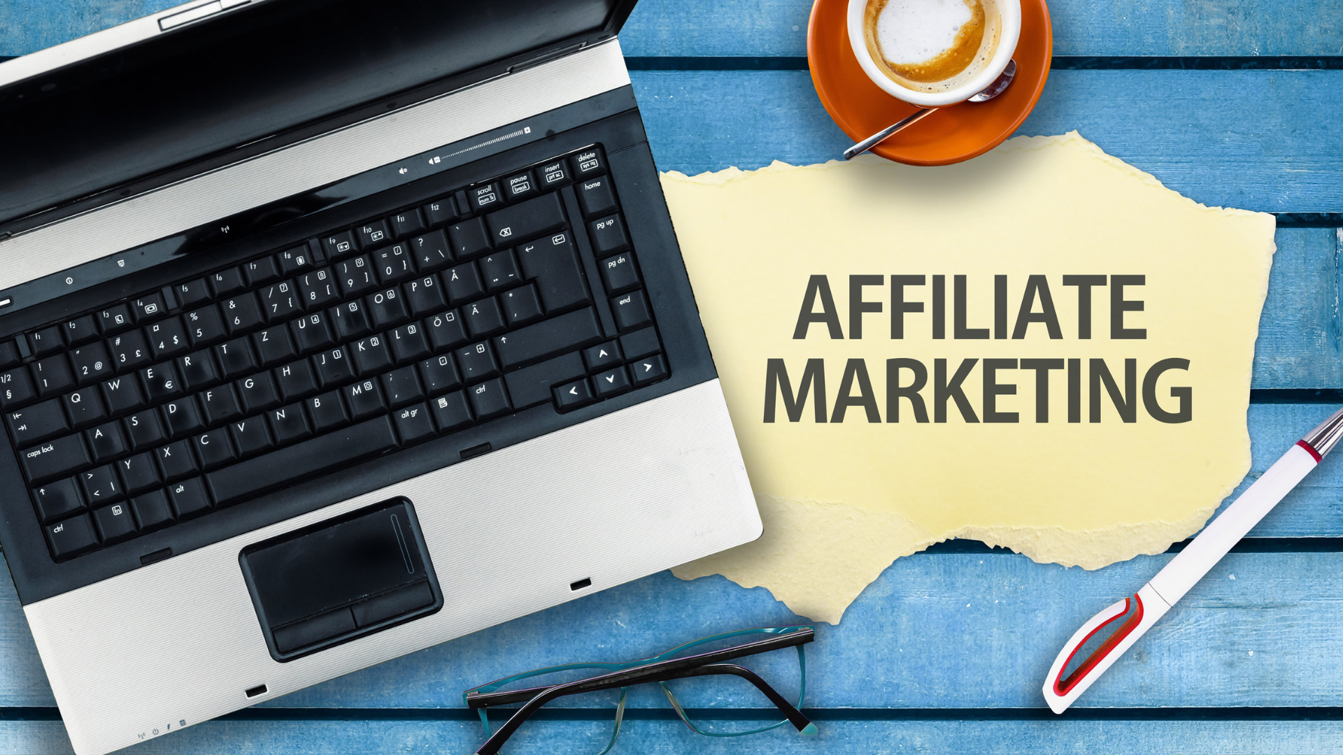 Affiliate marketing picture with a laptop, a tea cup, and a pen. Naitech Digital can help you with training on better online digital marketing recommendations.